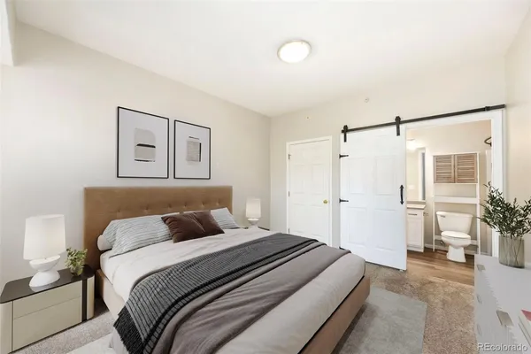 a bedroom with a large bed and a shower