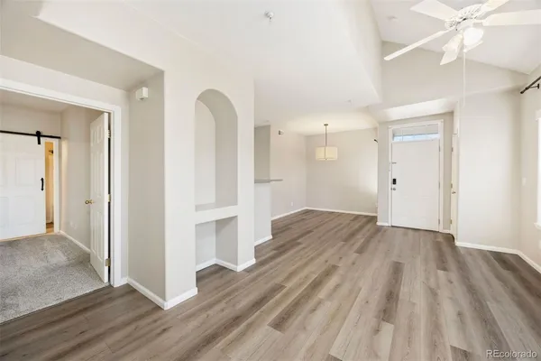a view of empty room with wooden floor