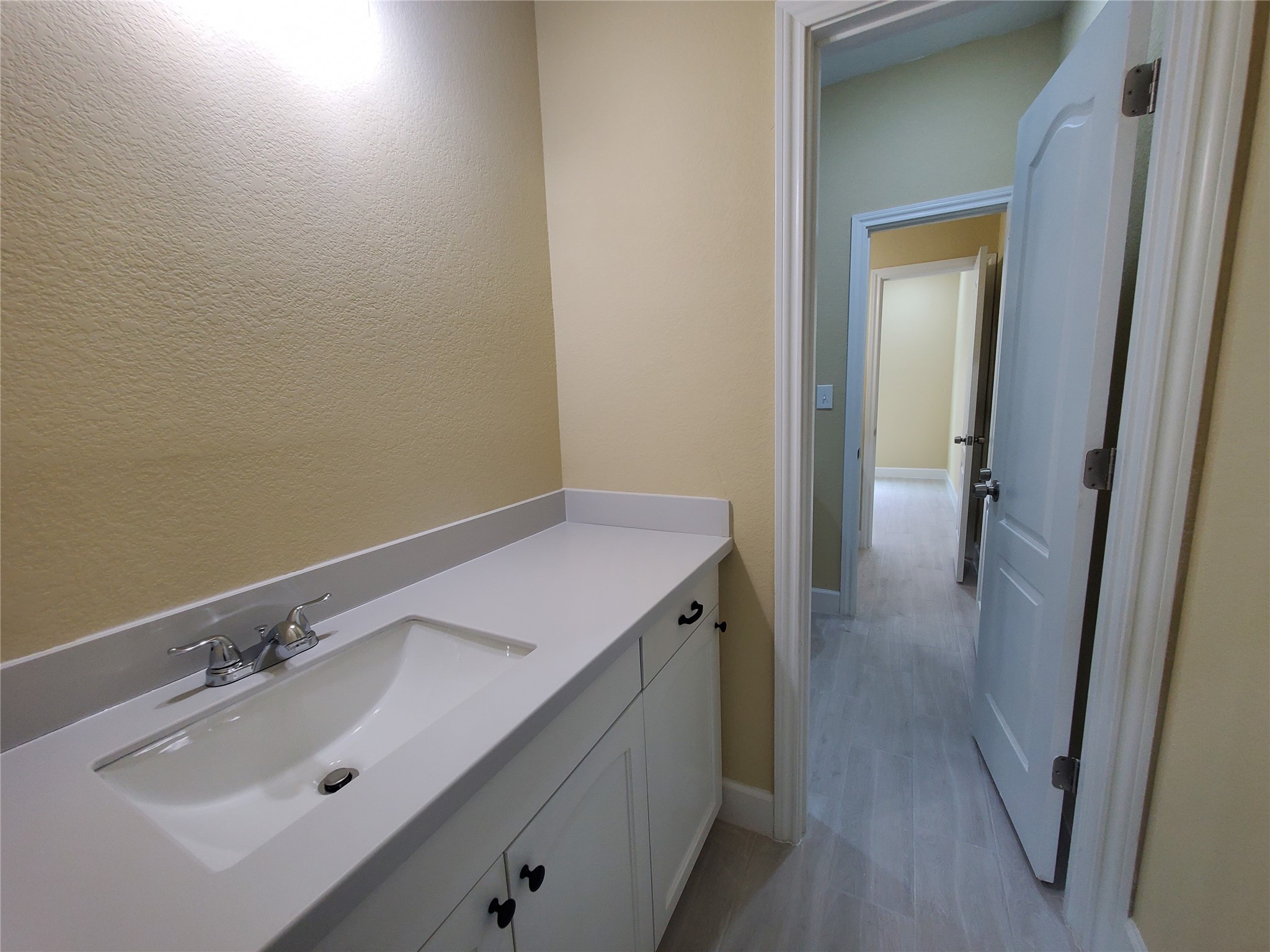1306 North 9th Street Conroe, TX 77301 - Photo 37 of 47 a bathroom with a sink and mirror