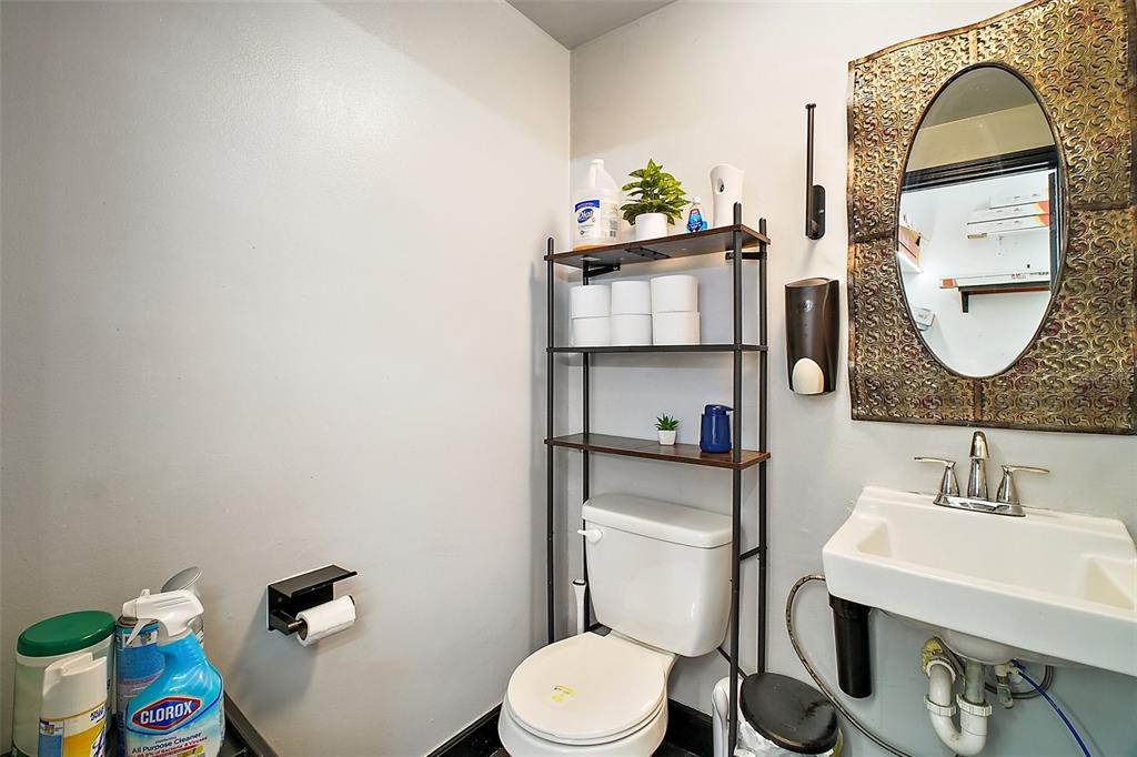 3101 Kurt Street Eustis, FL 32726 - Photo 14 of 43 a bathroom with a toilet sink and mirror