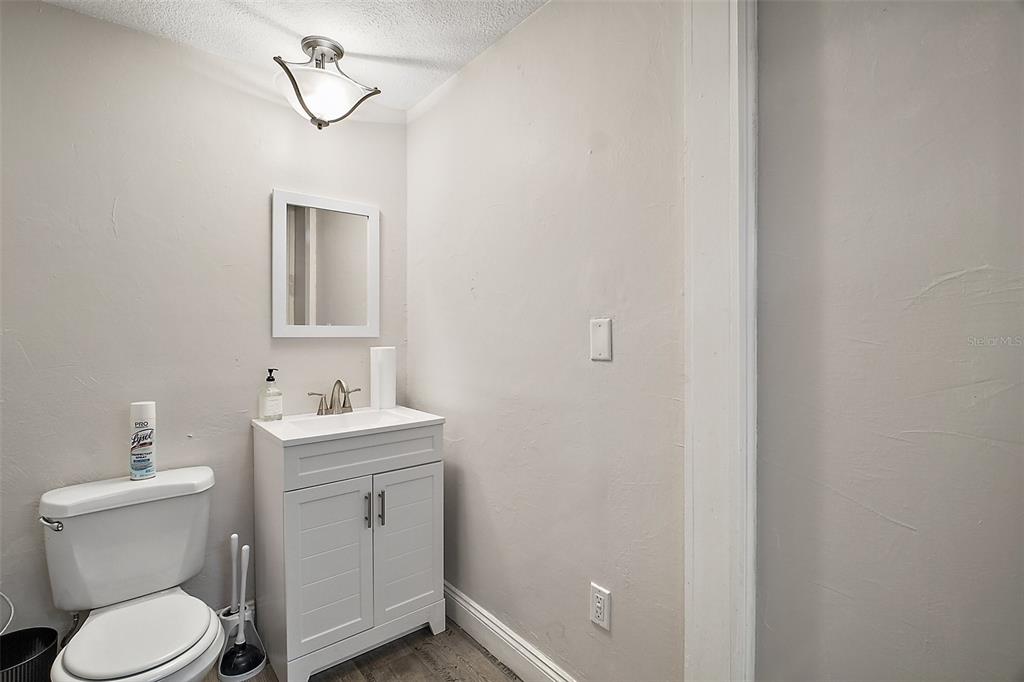 3101 Kurt Street Eustis, FL 32726 - Photo 20 of 43 a bathroom with a toilet a sink and mirror