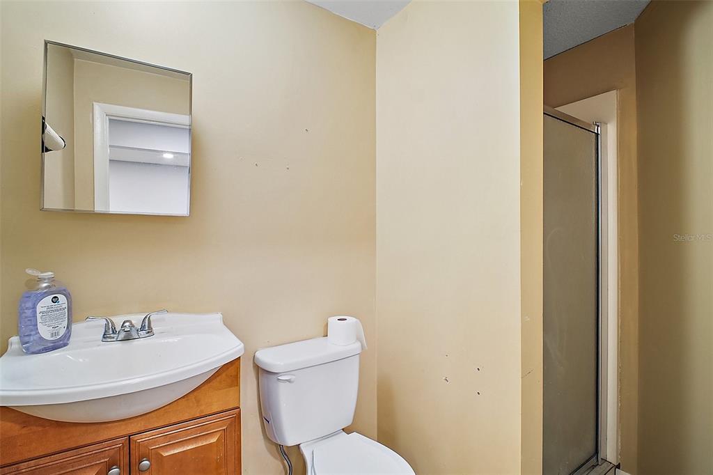 3101 Kurt Street Eustis, FL 32726 - Photo 33 of 43 a bathroom with a toilet sink and mirror