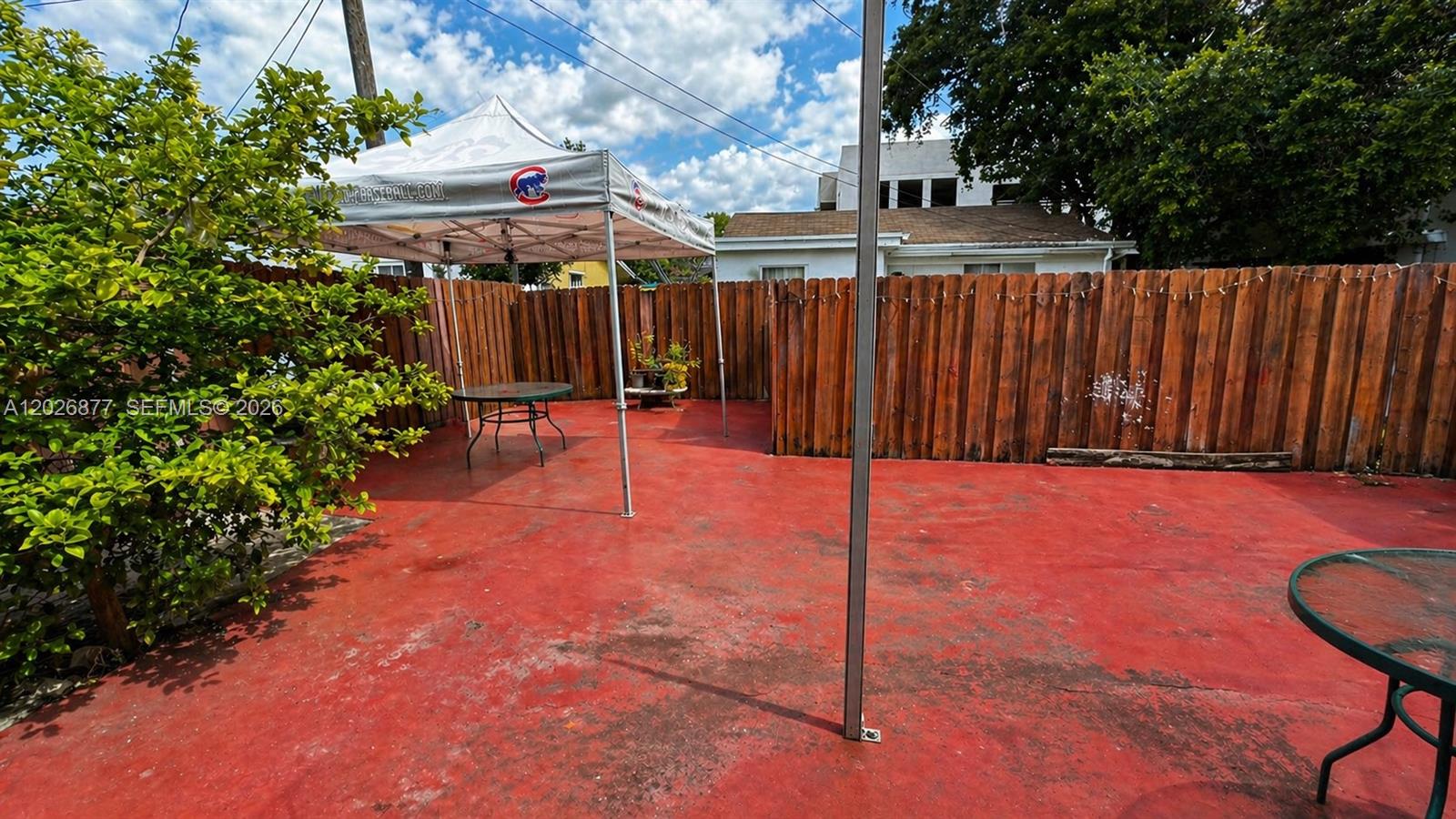 2727 Southwest 24th Street Miami, FL 33145 - Photo 9 of 18 a backyard of a house with table and chairs