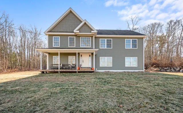 a front view of a house with a yard