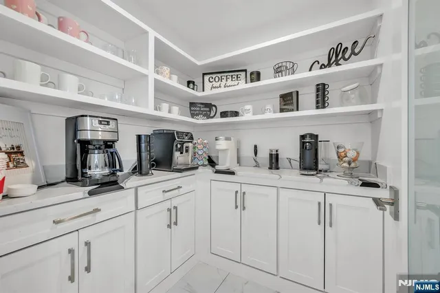 a large kitchen with cabinets a sink and a stove