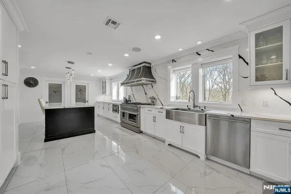 a bathroom with a sink mirror vanity and toilet