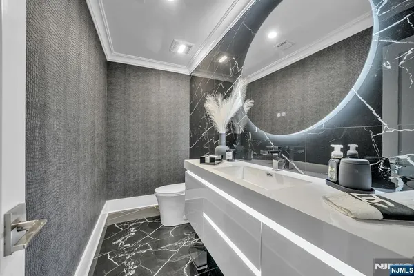 a living room with furniture a flat screen tv and a potted plant