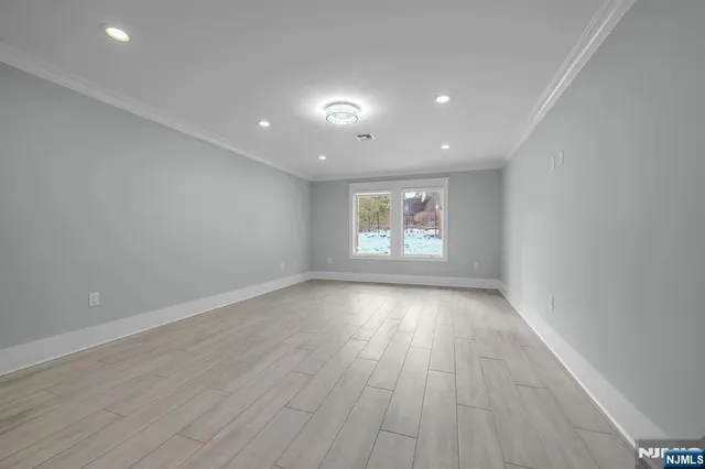 a bedroom with furniture and a flat screen tv