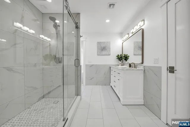 a kitchen with stainless steel appliances sink a stove and cabinets