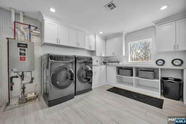 a spacious bedroom with a large bed and a flat screen tv