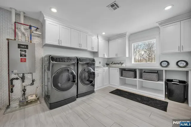 a spacious bedroom with a large bed and a flat screen tv