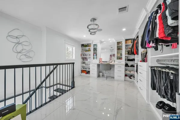 a view of a kitchen with fridge and workspace