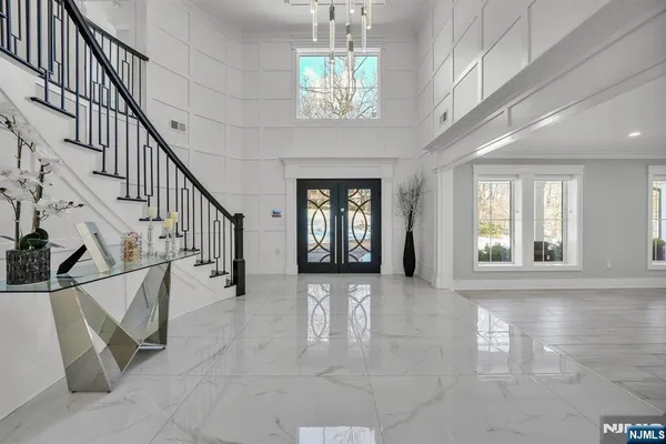 a view of entryway and hall with wooden floor