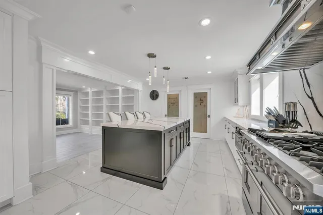 a kitchen with stainless steel appliances kitchen island granite countertop a sink and cabinets