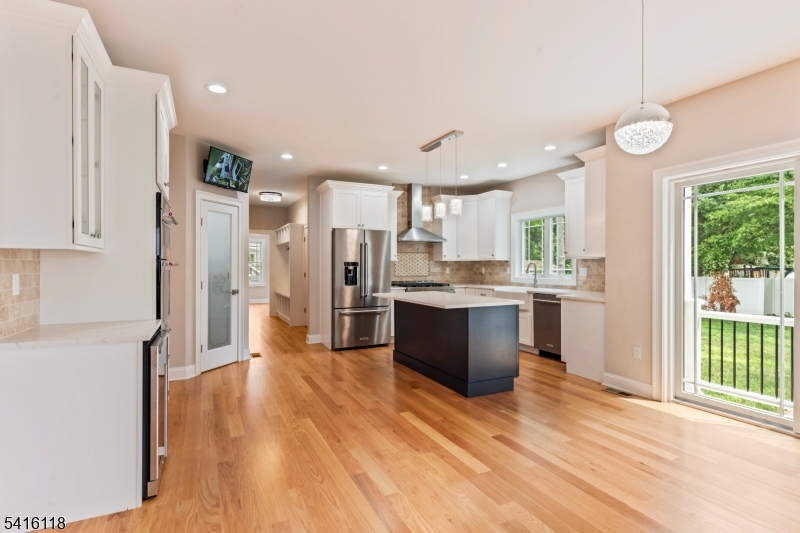 118 Cambridge Road Westfield, NJ 07090 - Photo 12 of 50 a view of kitchen with stainless steel appliances kitchen island wooden floor and window