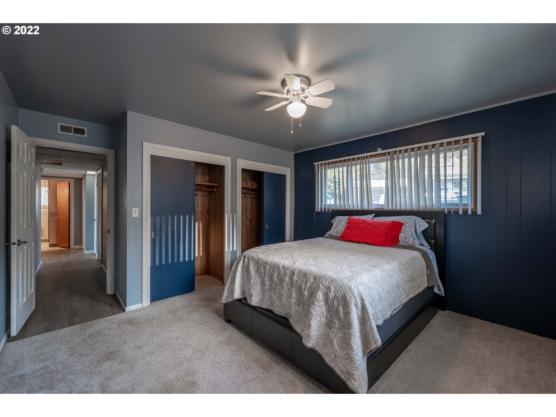 643 South State Street Sutherlin, OR 97479 - Photo 12 of 32 a bedroom with a large bed and a chandelier