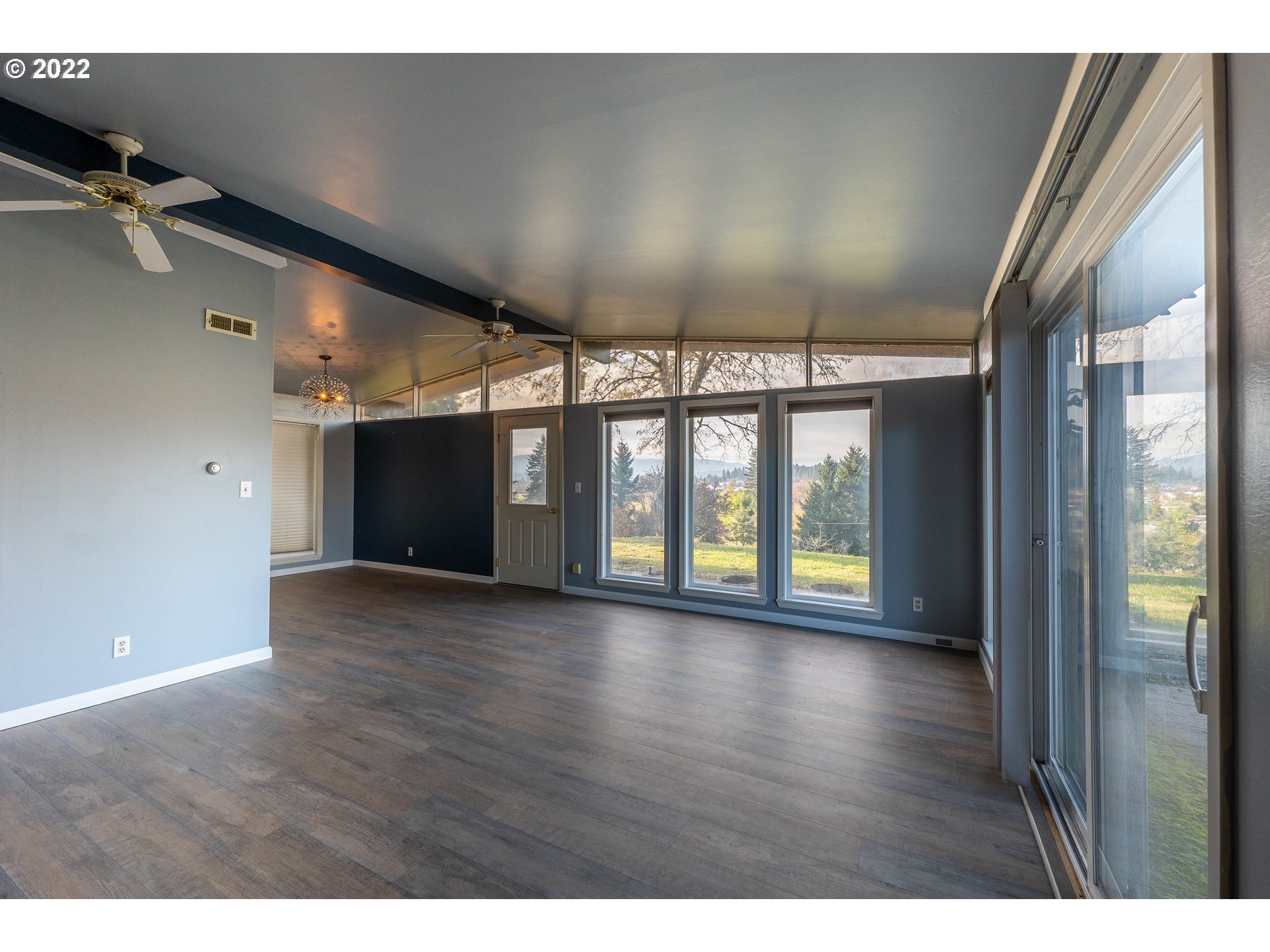 643 South State Street Sutherlin, OR 97479 - Photo 5 of 32 a view of an empty room with wooden floor and a window