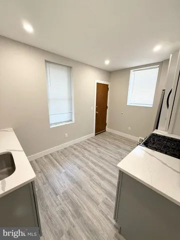 a room with a bed and a dresser