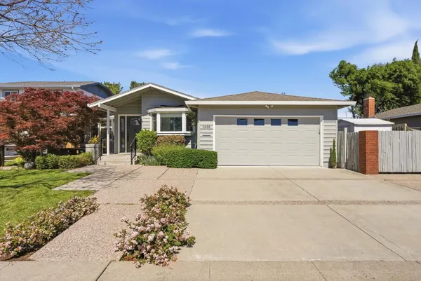 a front view of a house with a garden