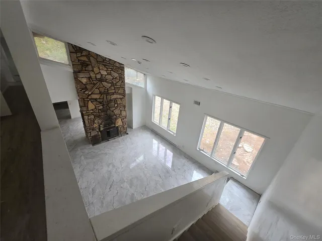 a view of empty room with fireplace and window