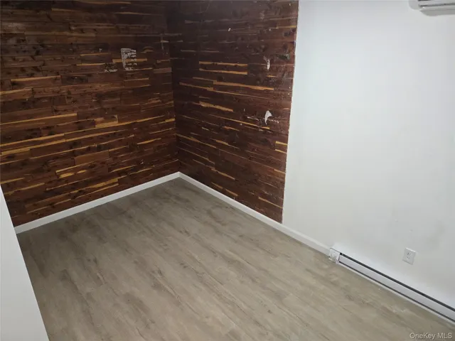 a view of a small space with wooden floor and a window