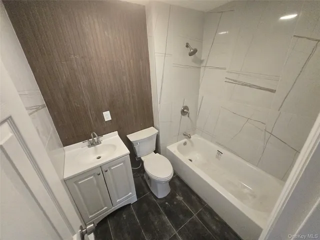 a white toilet sitting next to a shower
