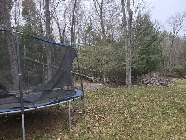 a backyard of a house with a table and chairs