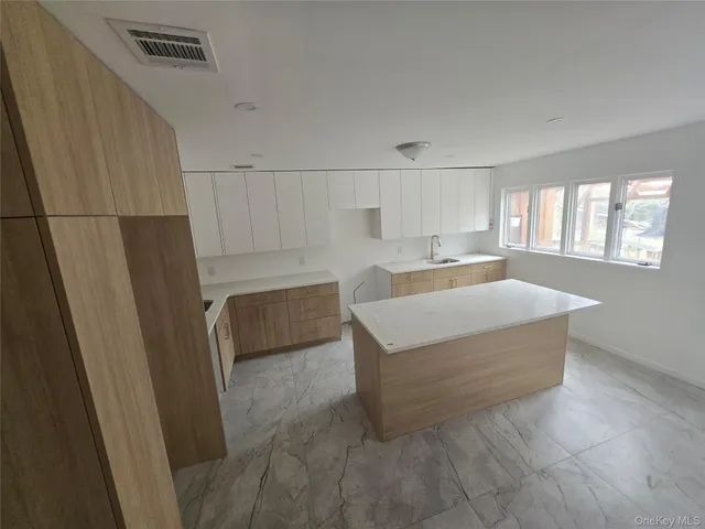 a living room with a couch and a refrigerator