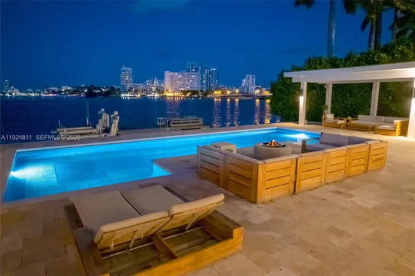 a view of a chairs and tables on the roof deck