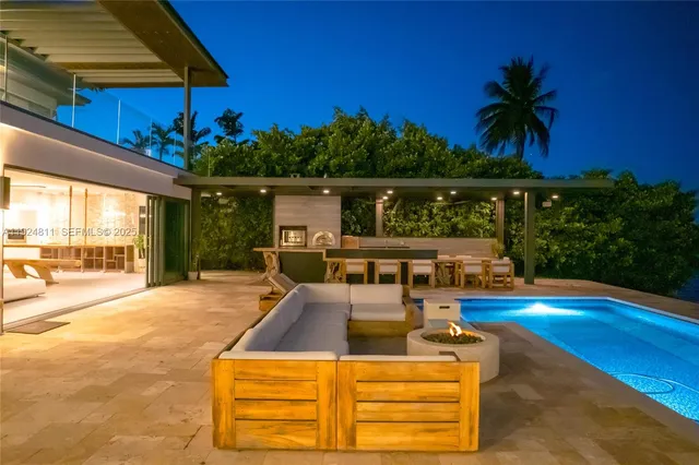 a view of a swimming pool with an outdoor seating and a yard