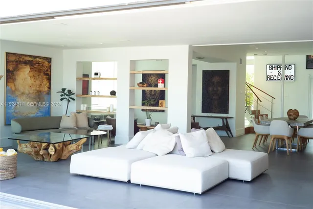 a living room with furniture and a painting on the wall