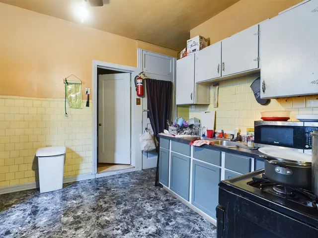 a kitchen with stainless steel appliances a stove a refrigerator and a sink