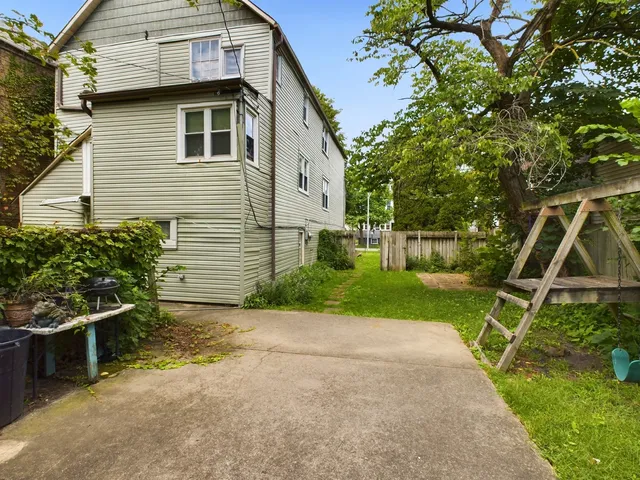 a view of backyard with a table and a chair