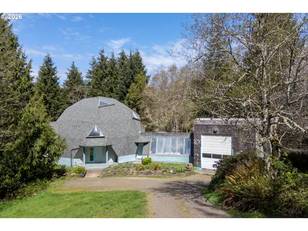 a aerial view of a house with a yard and garage