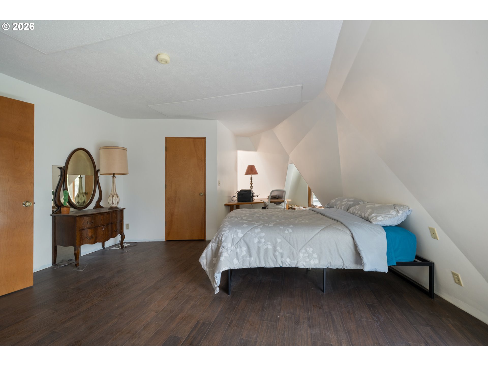 2500 Whiskey Creek Road Tillamook, OR 97141 - Photo 18 of 46 a bedroom with a bed and a potted plant