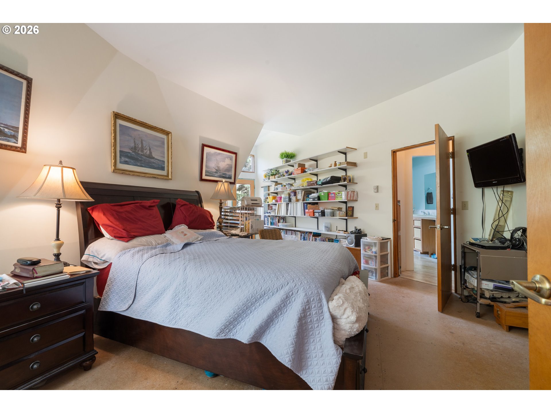 2500 Whiskey Creek Road Tillamook, OR 97141 - Photo 23 of 46 a bedroom with a bed and a flat tv screen on dresser