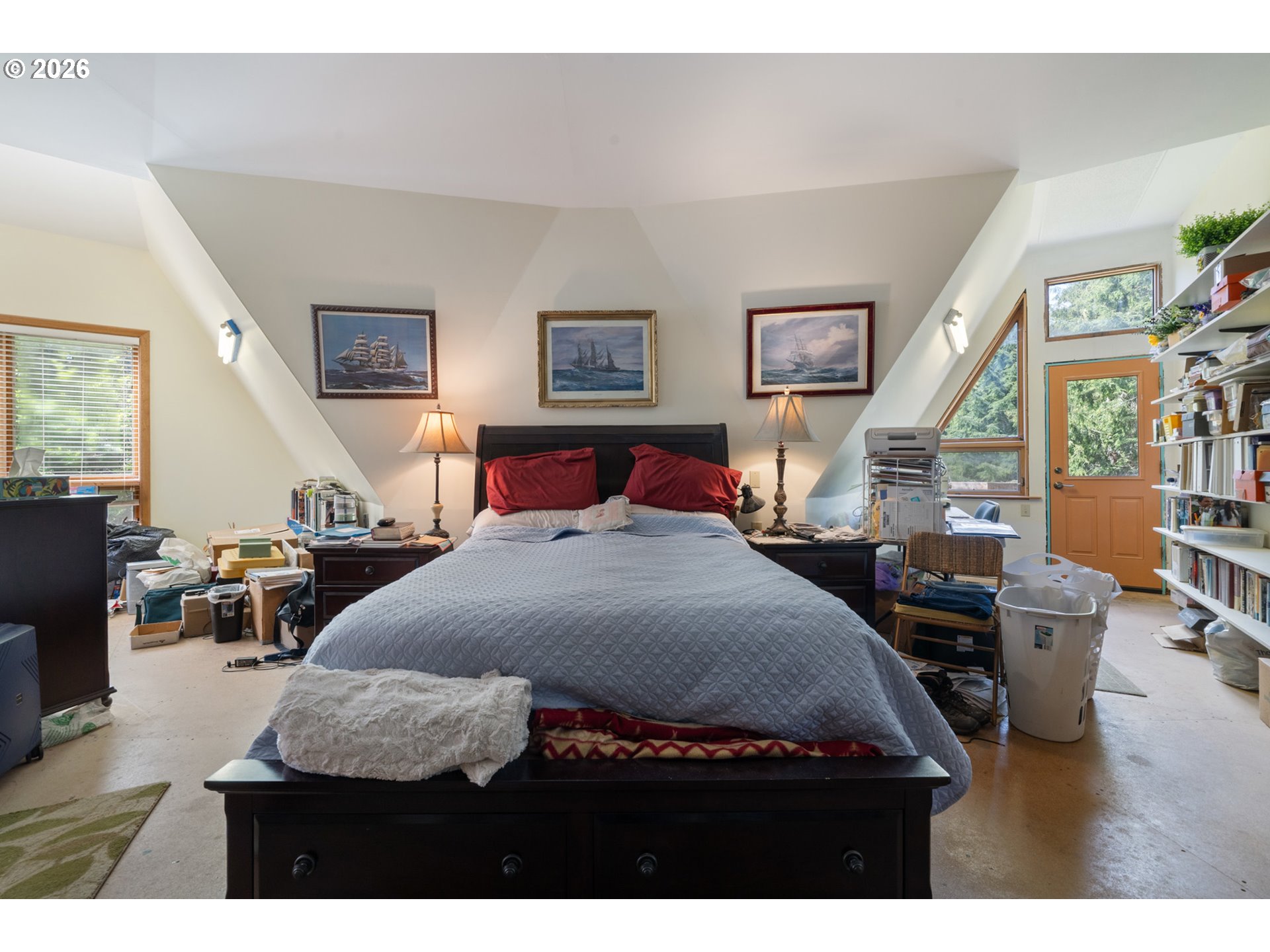 2500 Whiskey Creek Road Tillamook, OR 97141 - Photo 24 of 46 a bedroom with a large bed and a wooden floor
