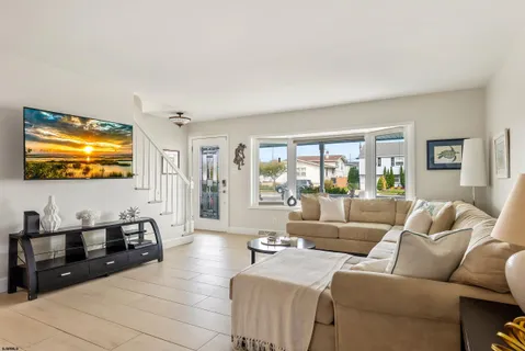 a view of a dining room with furniture and a chandelier
