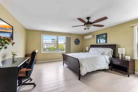 a bedroom with a bed and a chandelier