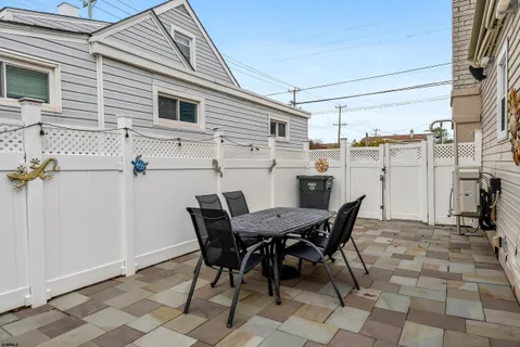 a view of a dinning table and chairs in the balcony