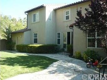 a view of a house with a yard and plants