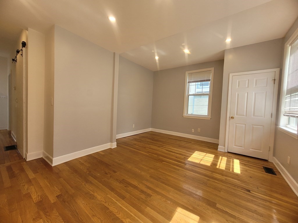 32 Cedar Street, Unit L Boston, MA 02126 - Photo 13 of 18 a view of empty room with wooden floor and fan