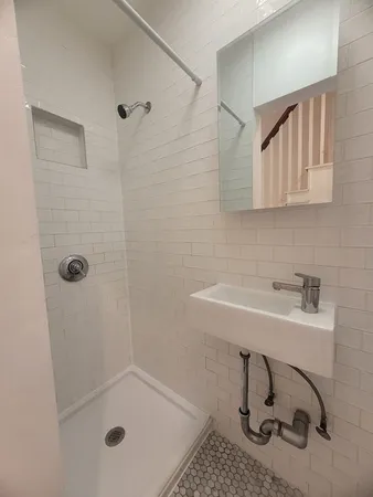 a bathroom with a sink and shower