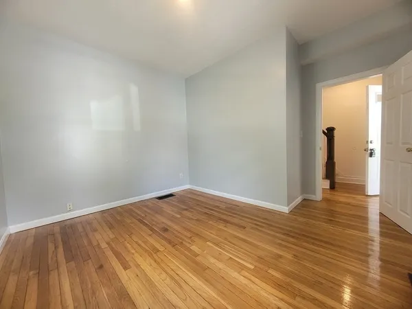 a view of an empty room and wooden floor