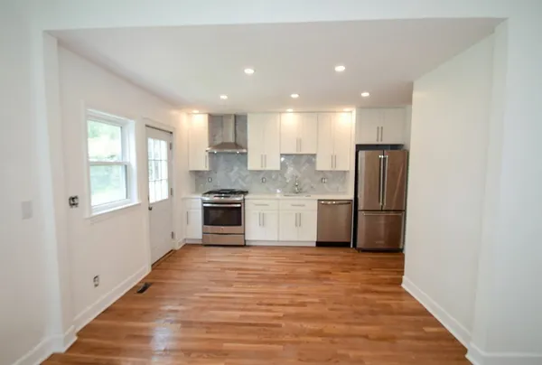 a kitchen with stainless steel appliances granite countertop a refrigerator sink and cabinets