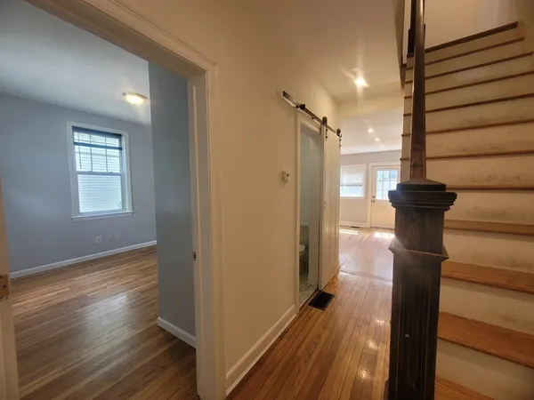 a view of hallway with wooden floor