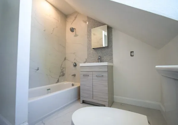 a bathroom with a sink toilet and shower