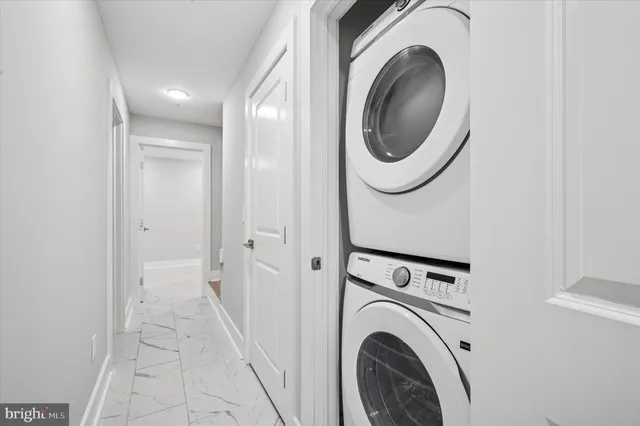 a view of a hallway with washer and dryer
