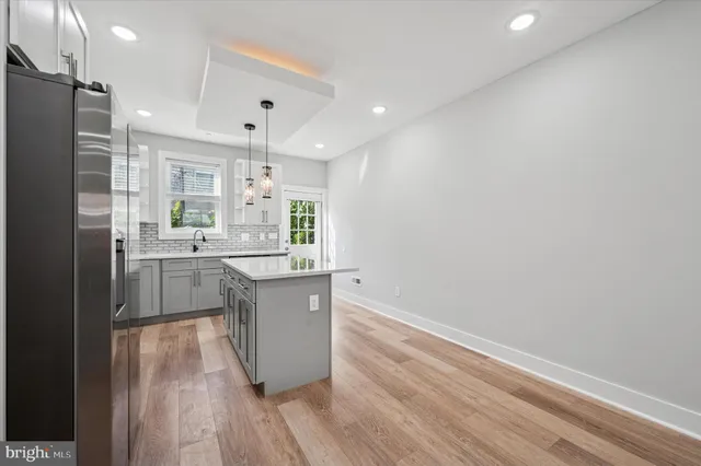 a kitchen with a sink cabinets stainless steel appliances and a window
