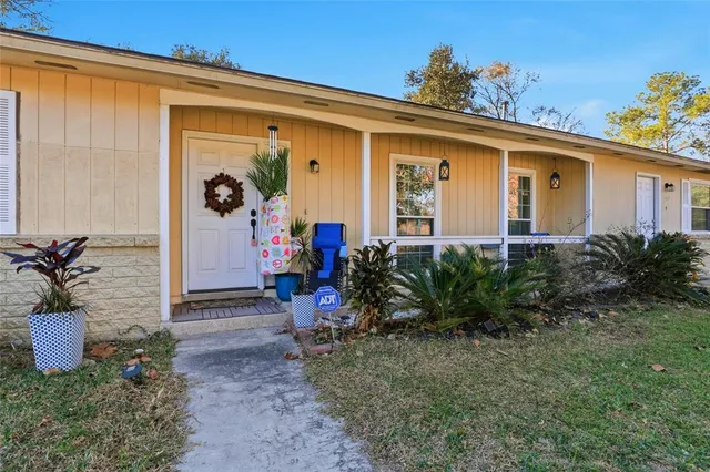 a view of a house with backyard porch and sitting area